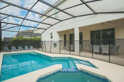 an indoor swimming pool with a glass ceiling at EPIC 12 Bedroom Home with Private Pool in Kissimmee