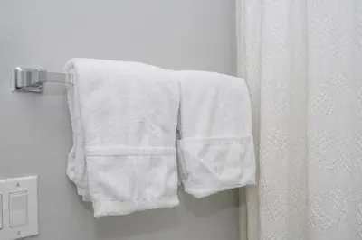 a white towel hanging on a towel rack in a bathroom at Beautiful Townhouse In Bella Vida Resort in Kissimmee