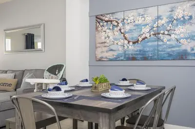 a dining room table with chairs and a painting on the wall at Beautiful Townhouse In Bella Vida Resort in Kissimmee
