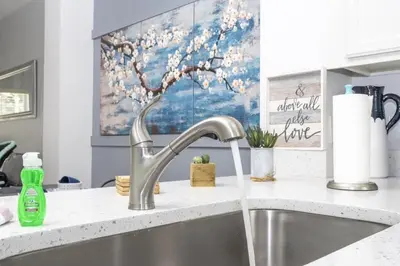 a kitchen sink with a faucet on a counter at Beautiful Townhouse In Bella Vida Resort in Kissimmee