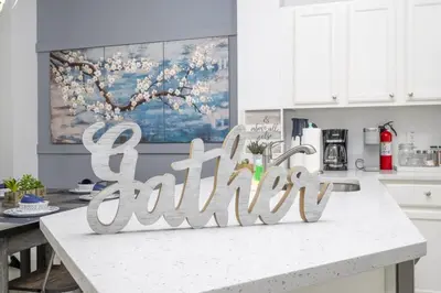 a kitchen counter with a sign that says so faith at Beautiful Townhouse In Bella Vida Resort in Kissimmee