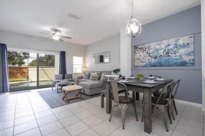a living room with a table and a couch at Beautiful Townhouse In Bella Vida Resort in Kissimmee