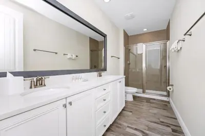a white bathroom with a sink and a toilet at Key Lime Villa By The Lake Near Disney With Margaritaville Resort & Island H20 Waterpark Access - 3105Cs in Orlando