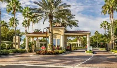 a building with palm trees in front of a street at Townhome Perfectly Located Near Clubhouse in Kissimmee