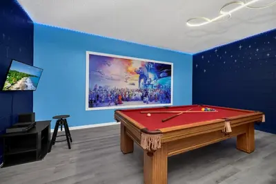 a room with a pool table and a painting at Remodeled 7 Bedroom Retreat Near Disney World in Kissimmee