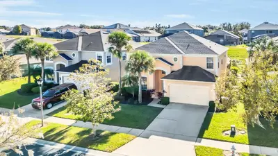 an aerial view of a house with palm trees at Emerald Island Resort 6 bedroom 4 bathroom luxury in Kissimmee