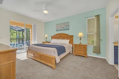 a bedroom with a bed and a dresser and a window at Emerald Island Resort 6 bedroom 4 bathroom luxury in Kissimmee