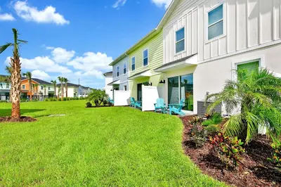a house with a lawn in front of it at Lovely Villa Near Disney With Margaritaville Resort Access - 3124Cs in Orlando