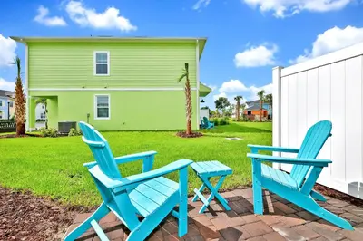 two blue chairs and a table in front of a house at Lovely Villa Near Disney With Margaritaville Resort Access - 3124Cs in Orlando