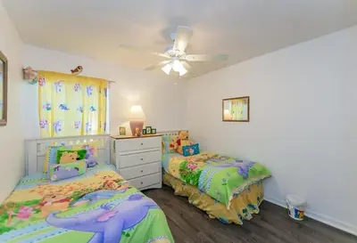 a bedroom with two beds and a ceiling fan at Beautiful Pool Home by Disney World in Orlando