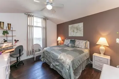 a bedroom with a bed and a desk and a desk at Beautiful Pool Home by Disney World in Orlando