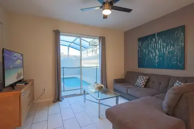 a living room with a couch and a tv at Magical Townhome private pool in Storey Lake in Kissimmee