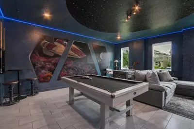 a living room with a pool table in the middle at Storey Lake Dream Villa with Private Pool in Kissimmee