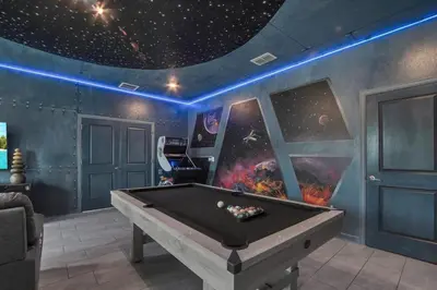 a pool table in a room with a star ceiling at Storey Lake Dream Villa with Private Pool in Kissimmee