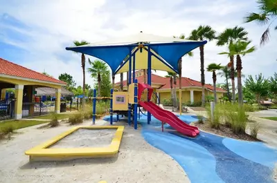 a playground with a slide and an umbrella at Wonderful Terra Verde Orlando Vacation Home in Kissimmee