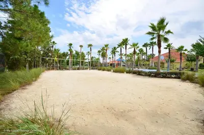 an empty volleyball court with palm trees and houses at Wonderful Terra Verde Orlando Vacation Home in Kissimmee