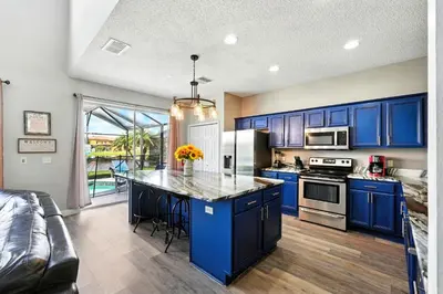 a kitchen with blue cabinets and a counter top at Wonderful Terra Verde Orlando Vacation Home in Kissimmee
