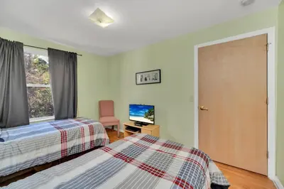 a bedroom with two beds and a tv and a window at Incredible Island Club Villa Condo in Kissimmee