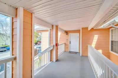 a porch of a home with a white railing at Incredible Island Club Villa Condo in Kissimmee