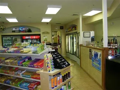 a store aisle of a food store with a counter at 3 Bedrooms Condo Only Minutes From Disney in Orlando