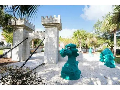 a green toy dog in front of a castle at 3 Bedrooms Condo Only Minutes From Disney in Orlando