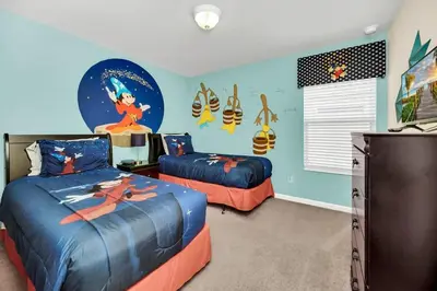 two beds in a room with a disney bedroom at Windsor Hills Dream Private Screened Pool Home in Orlando