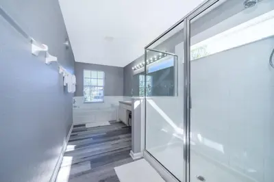 a bathroom with a glass shower stall and a sink at Luxury 6 Bedroom Pool Home in Windsor Hills in Orlando