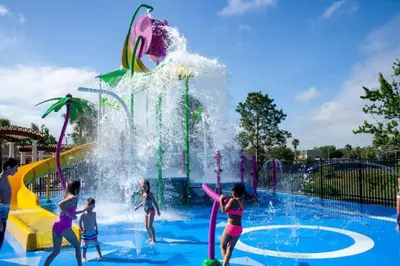 a group of children playing in a water park at Luxury 6 Bedroom Pool Home in Windsor Hills in Orlando