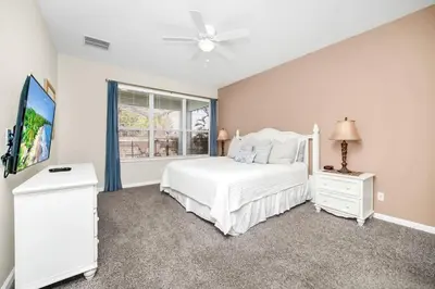 a bedroom with a white bed and a window at Newly Upgraded Disney Themed Vacation Retreat in Orlando