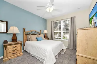 a bedroom with a bed and a ceiling fan at Newly Upgraded Disney Themed Vacation Retreat in Orlando