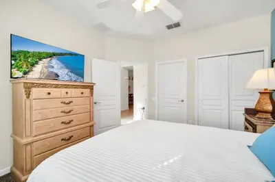 a bedroom with a bed and a tv on a dresser at Newly Upgraded Disney Themed Vacation Retreat in Orlando