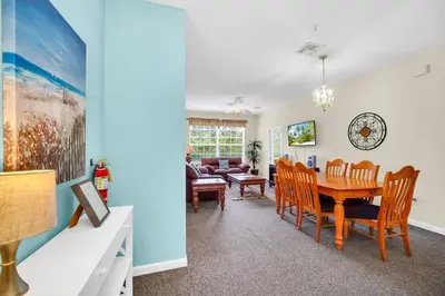 a dining room and living room with a table and chairs at 3 Bedroom 2 Bath Condo in Windsor Palms Resort in Kissimmee