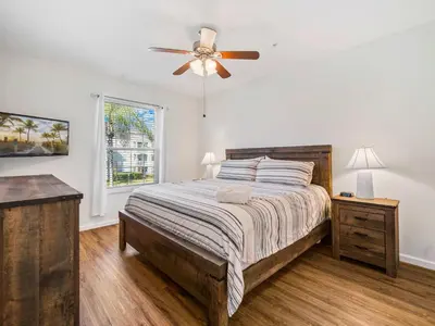 a bedroom with a bed and a ceiling fan at Newly Remodel Kitchen with All New Appliances in Kissimmee