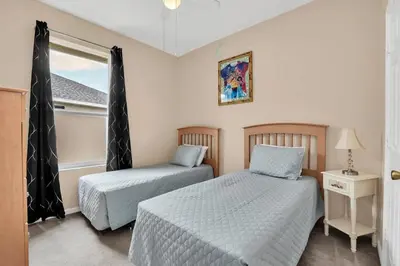 a bedroom with two beds and a window at Windsor Palms Villa with Very Private Pool in Kissimmee