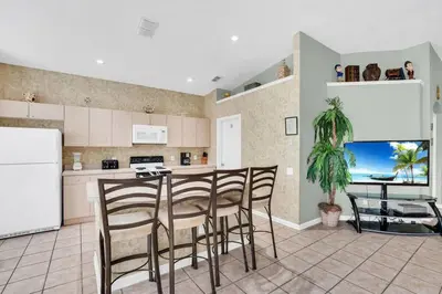 a kitchen with a table and chairs in a kitchen at Windsor Palms Villa with Very Private Pool in Kissimmee