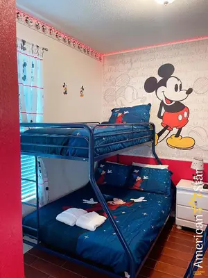 a bunk bed with mickey mouse on the wall at Cozy 3BR Apartment - Vista Cay Resort near Disney! in Orlando