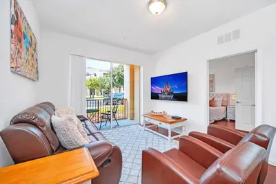 a living room with a couch and a table at Cozy 3BR Apartment - Vista Cay Resort near Disney! in Orlando