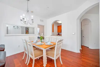a kitchen and dining room with a table and chairs at Cozy 3BR Apartment - Vista Cay Resort near Disney! in Orlando