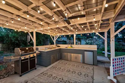 an outdoor kitchen with a stove and a grill at Tiny Home w MIL suite - 3 MI to DT in Orlando