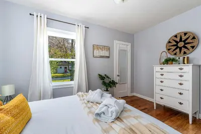 a bedroom with a white bed and a window at Tiny Home w MIL suite - 3 MI to DT in Orlando