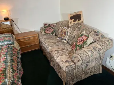 a living room with a couch and a bed at Red Brick House in Kissimmee