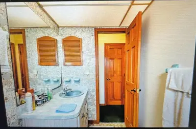 a bathroom with a sink and a mirror at Red Brick House in Kissimmee