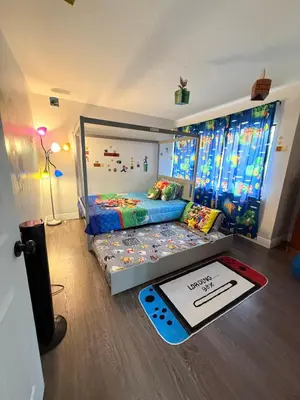 a bedroom with a bed in a room with windows at Central Hub in Orlando