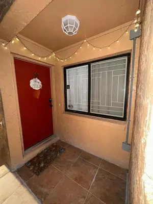 a room with a red door and a window at Central Hub in Orlando
