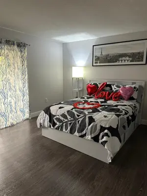 a bedroom with a bed with a black and white comforter at Central Hub in Orlando