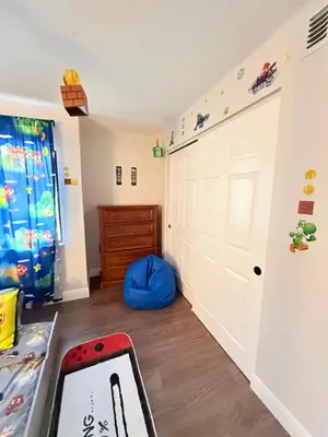 a room with a white garage door and a bed at Central Hub in Orlando