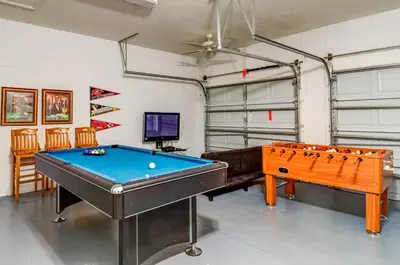 a room with a pool table and a tv at Olivia's Dream Villa on WindsorHills in Orlando