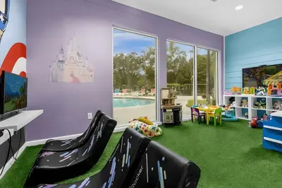 a childs play room with a castle on the floor at Casa 4Q Lucaya com Temas Disney e Clubhouse in Kissimmee