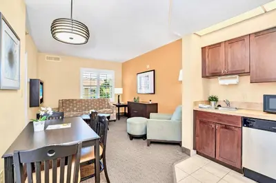 a living room with a kitchen and a dining room at Apartment w Pool and Hot Tub - Near Disney in Orlando