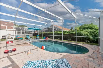 a swimming pool with a canopy over it at Chatham House in Kissimmee